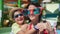 Laughing woman in big funny glasses hugging little son enjoying vacation having fun together