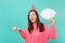 Laughing woman in birthday hat looking up hold cake with candle, empty blank Say cloud, speech bubble for promotional
