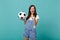 Laughing woman football fan cheer up support favorite team with soccer ball pointing index finger on camera isolated on