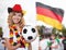 Laughing woman in german jersey with ball and other fans