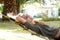 Laughing woman lying in hammock outside of house