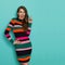 Laughing Woman In Vibrant Striped Dress Is Pointing