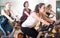 Laughing women of different age training on exercise bikes