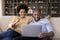 Laughing young african american family couple celebrating internet success.