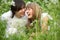 Laughing young pair sits in grass