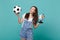 Laughing young woman football fan cheer up support favorite team with soccer ball, world globe isolated on blue