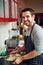 Laughter is brightest, where food is best. a young man rinsing pasta at home.