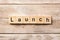 Launch word written on wood block. launch text on table, concept