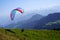 Launching a paraglide downhill in a tandem flight in Switzerland.