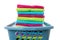 Laundry basket filled with colorful folded towels