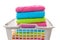 Laundry basket filled with colorful folded towels