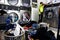 Laundry baskets filled with dirty clothes are lined up inside a laundromat
