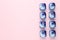Laundry capsules on pink background, flat lay. Space for text