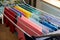 Laundry day Rainbow color clothes hanging on washing line to dry indoors home