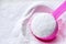 Laundry detergent powder and pink plastic scoop