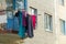 Laundry dried outside the window. Balcony with clothes dryer.