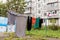 Laundry dries on the rope in courtyard of Khrushchyovka. Khrushchyovka is common type of old low-cost apartment building in Russia