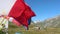 Laundry and flags in mountains. Clothes hanging to dry, flags waving in wind and blue sky in summer in Aosta, Italy.