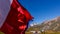 Laundry and flags in mountains. Clothes hanging to dry, flags waving in wind and blue sky in summer in Aosta Valley in Italy