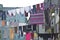 Laundry hanging in front of the windows of the facade in