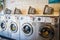 Laundry or landrette  with coin  operated front loading washing machines and landry baskets on top