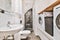 Laundry room with sink and wooden shelf