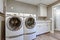 Laundry room with taupe walls and modern appliances.