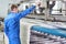 Laundry worker in the process of working on automatic machine for carpet washing