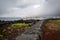 Lava coastline with a lava wall at the port on the island of Pico