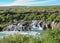 Lava falls Hraunfossar run as tiny waterfalls and rapids into the Hvita River, Borgarfjordur, West Iceland, Europe