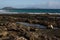 Lava fields. Black minerals. Coastal zone between land and water at the Fuerteventura and Atlantic ocean. Spain, Europe.