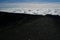 Lava hill climbing above the clouds on Etna`s volcano