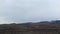 Lava plains with black volcanic sand and stones. Burnt earth.