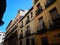 Lavapies neighborhood windows and balconies of Madrid city buildings facades