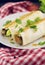 Lavash rolls with meat, vegetables and cheese served with green