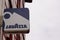 Lavazza logo and sign of coffee shop advertising front of bar building facade and
