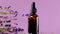 Lavender essential oil. glass bottles essential oil and lavender flowers on a purple background.Essence with lavender