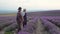 Lavender Farming. An agronomist and a farmer in a lavender field. Partners' handshake. Industrial cultivation of