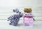 Lavender flowers bouquet and oil in glass bottle on wooden table cloth up. Relax therapy concept. Beauty and aromatherapy