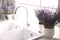 Lavender flowers on countertop near sink in kitchen