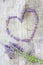 Lavender heart over wooden background.