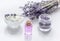 Lavender herbs in body care cosmetics with oil on white table background