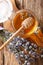 Lavender liquid honey in a glass jar close-up. Vertical top view