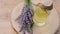 Lavender oil in a glass bottle and lavender sprigs on a wooden cut on a wooden table.Organic pure essential oil. Natural
