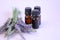 Lavender oil.Three brown glass pharmacy jars with lavender oil and lavender flowers on a lilac background.Organic pure