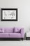 Lavender purple, trendy sofa and a framed photo mock-up in a gray living room interior with place for a lamp