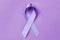 Lavender ribbon on color background. Cancer and epilepsy