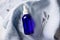 lavender spray in transparent glass bottle on linen sheet