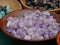 Lavender and white crystals and rocks in a wooden round bowl