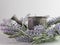 Lavender wreath around a rustic metal watering can on a clean white background.  Simple and elegant country home decor